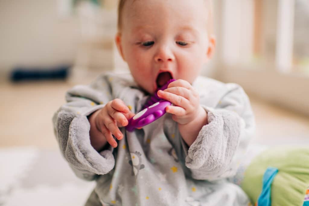 Image of baby with a teething toy