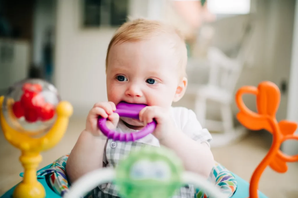 Image of baby with teething toy